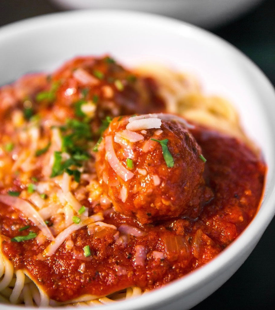 bowl of italian meatballs with spaghetti and cheese