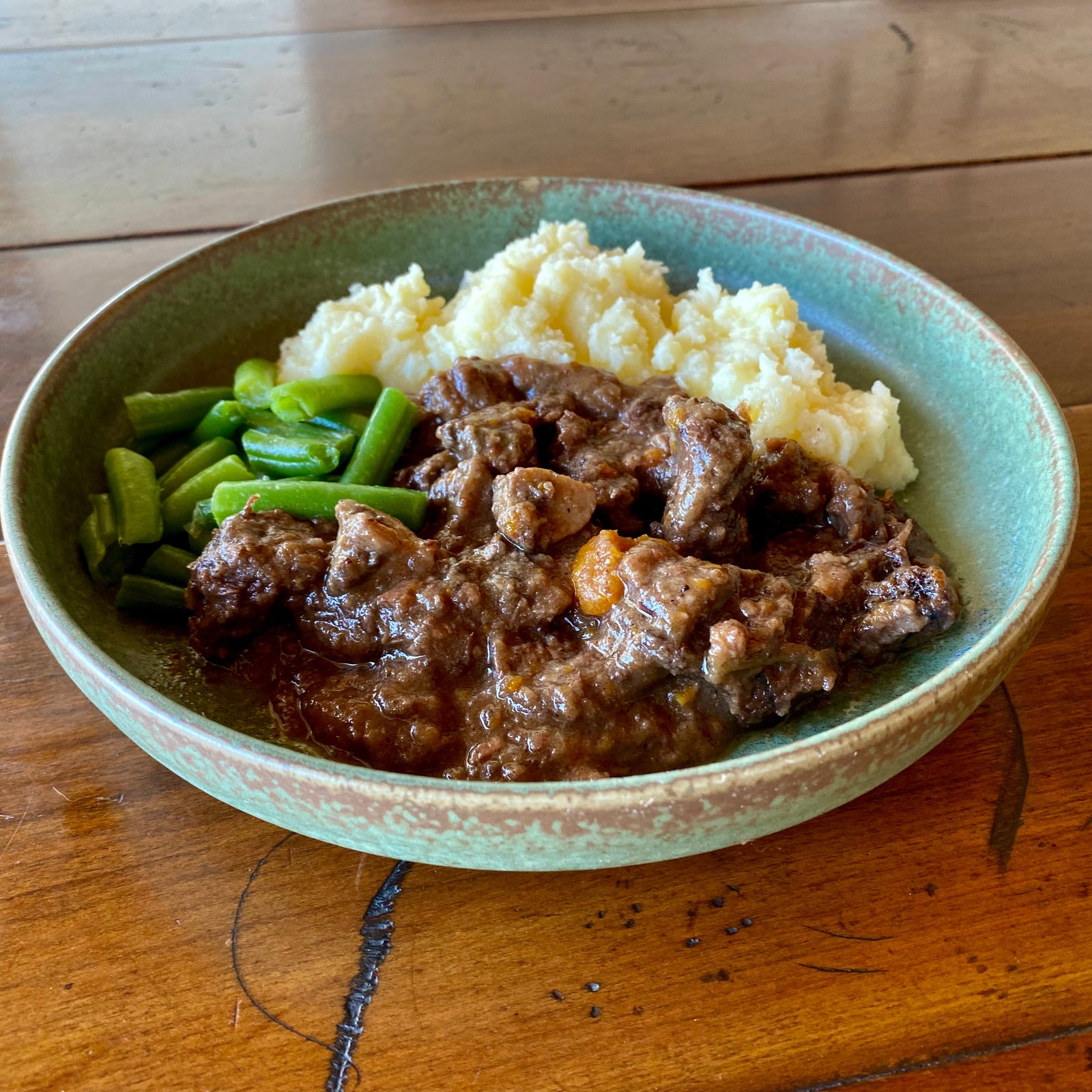 Our Beef Burgundy. Tender beef in a wine and herb sauce, served with our buttery mash and green beans.