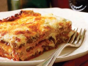 slice of lasagna on plate with fork
