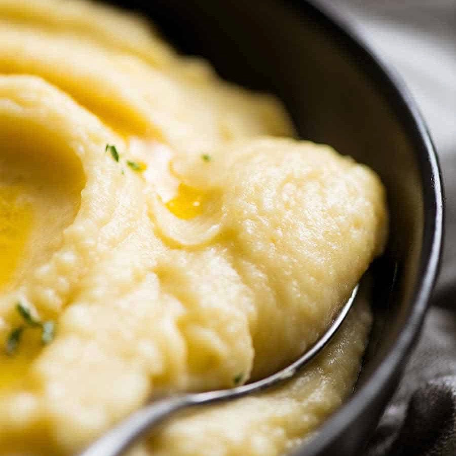 close up of creamy mashed potato being scooped from a bowl